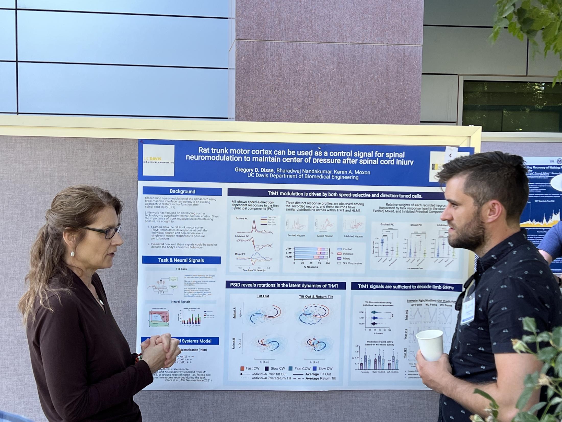 Graduate student Greg Disse discusses his poster with prof. Karen Moxon