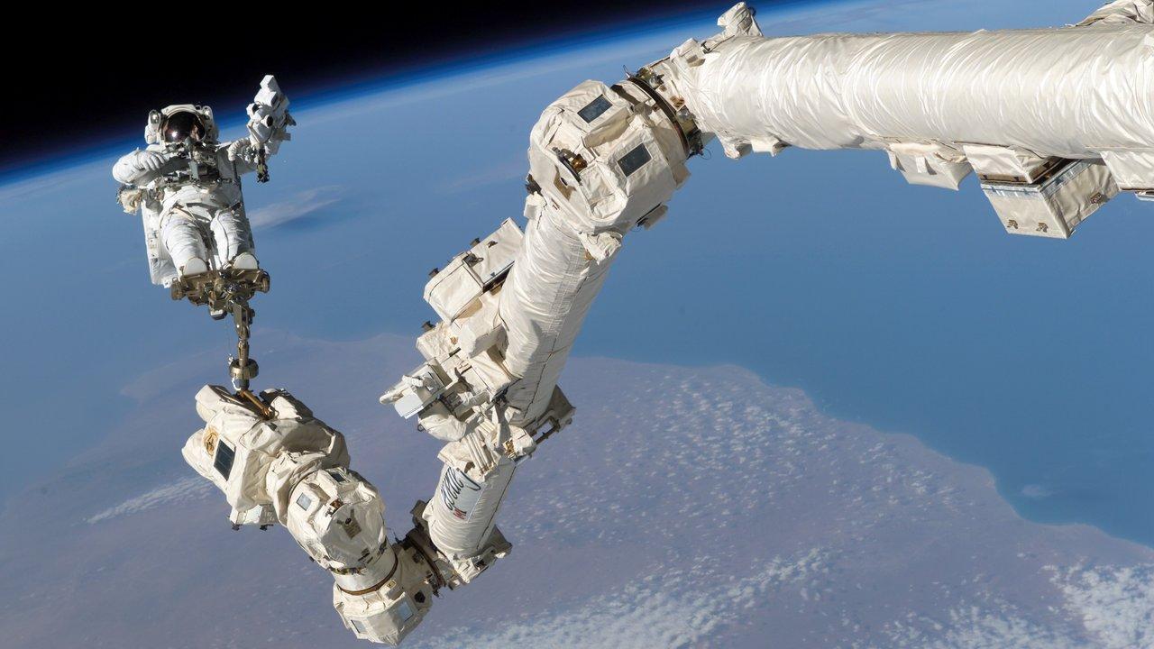 Professor Steve Robinson on one of the International Space Station's robotic arms. Robinson, Schofield and Joiner are studying ways to make these robotic arms easier to control.