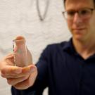 Sergey Stavisky holds a Neuropixels probe, which is used to record brain activity